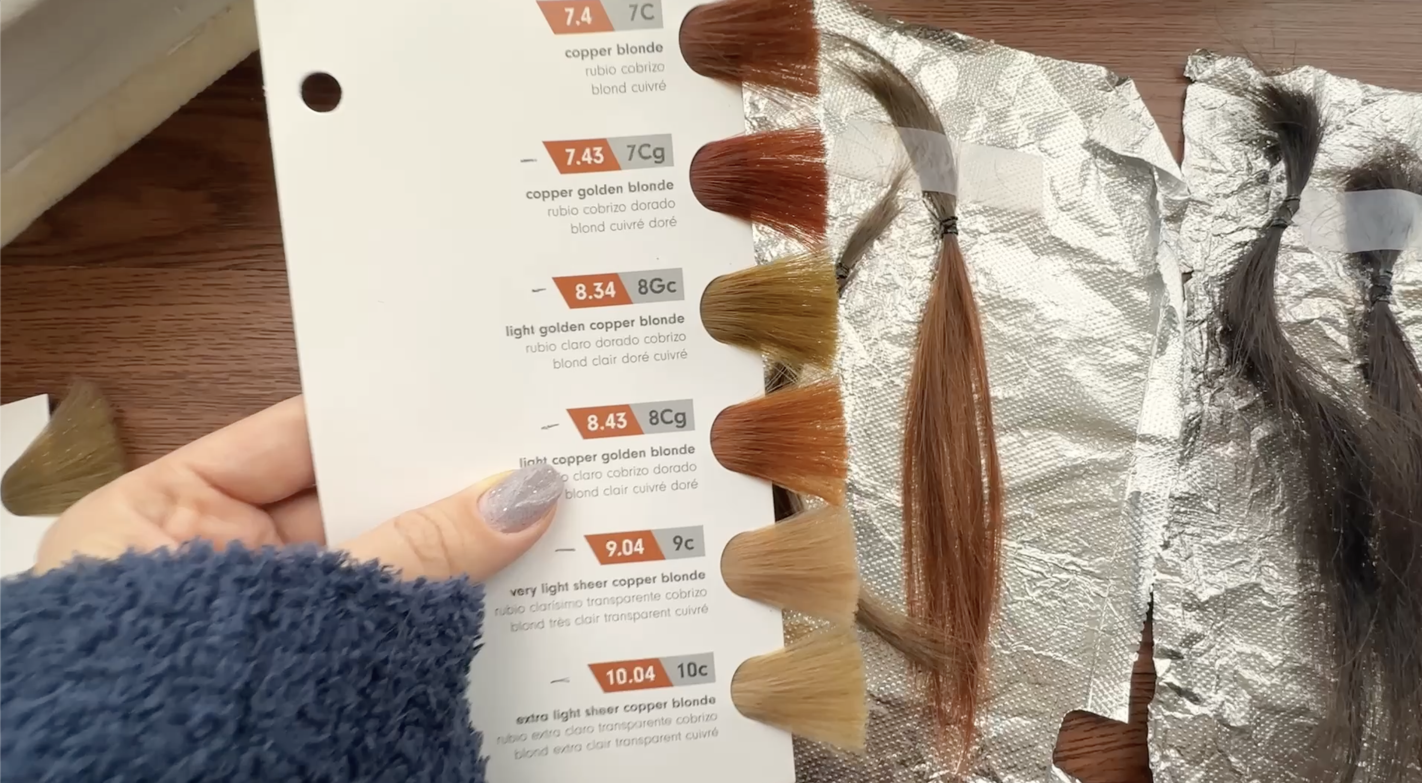 PHOTO-OF-DEVELOPER-VOLUME-TEST-SHOWING-HAIR-SWATCH-BOOK-AGAINST-HAIR-SWATCHES-FROM-EXPERIMENT